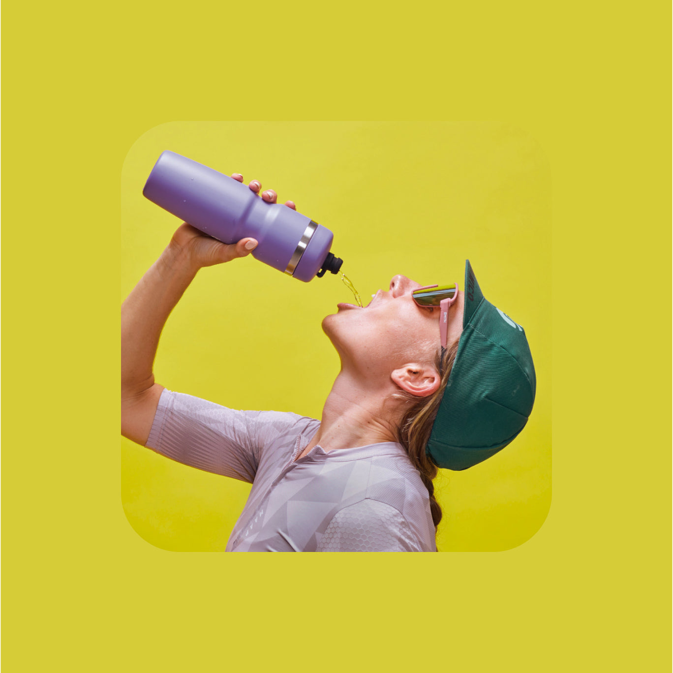 Person drinking from a lavender Bivo water bottle against a yellow background