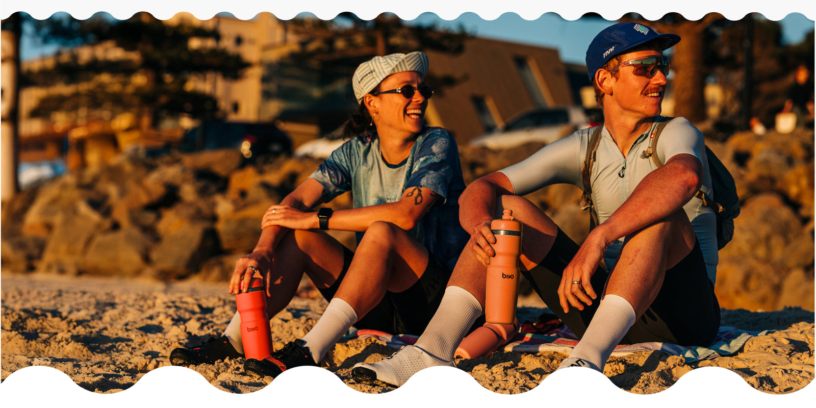 Matt and Jo sitting on a beach in Adelaide. Bivo is at events all around the world sharing our performance hydration expertise.