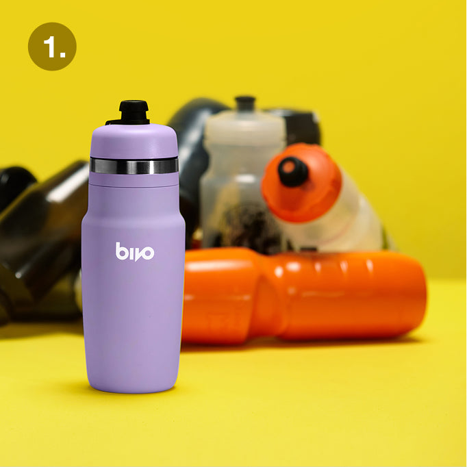 Purple Bivo water bottle with black cap on a yellow background