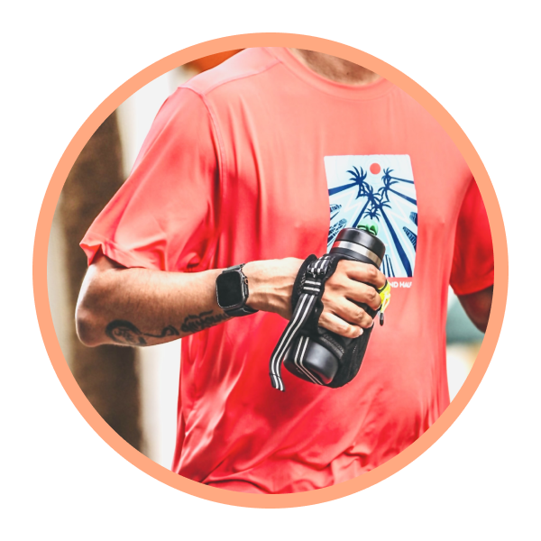 Person wearing a red t-shirt with a graphic design, holding a black Bivo water bottle.