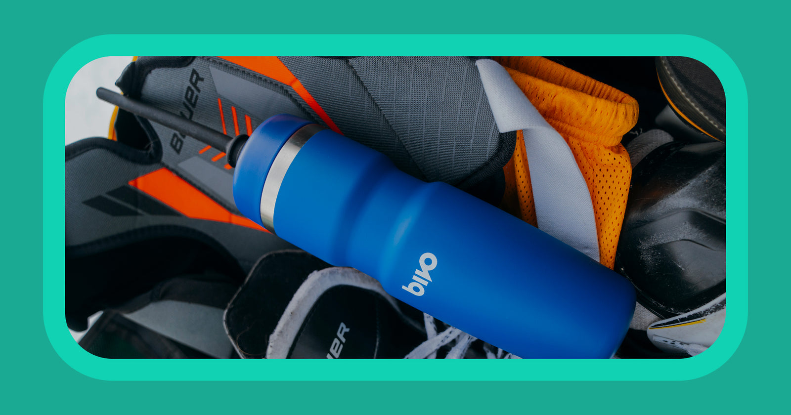 Blue water bottle with Bivo longshot bottle for hockey on a pile of hockey gear in a kit bag.