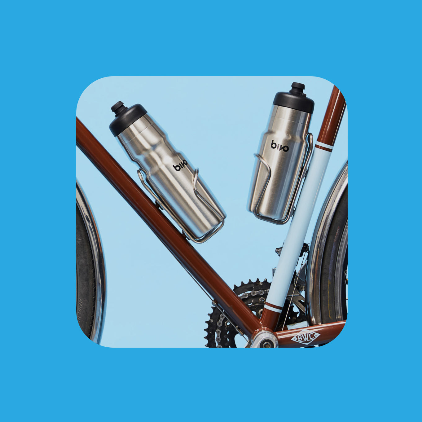 Two Raw Bivo bicycle water bottles in stanless steel bike cages on a breadwinner bike on a blue background
